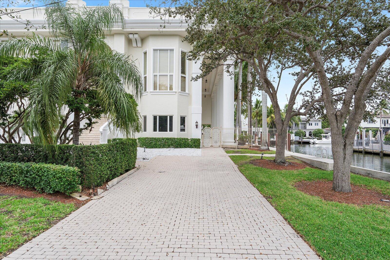 414 Riviera Isle Drive Fort Lauderdale, FL 33301 - Photo 5 of 70 a front view of a house with a yard and garden