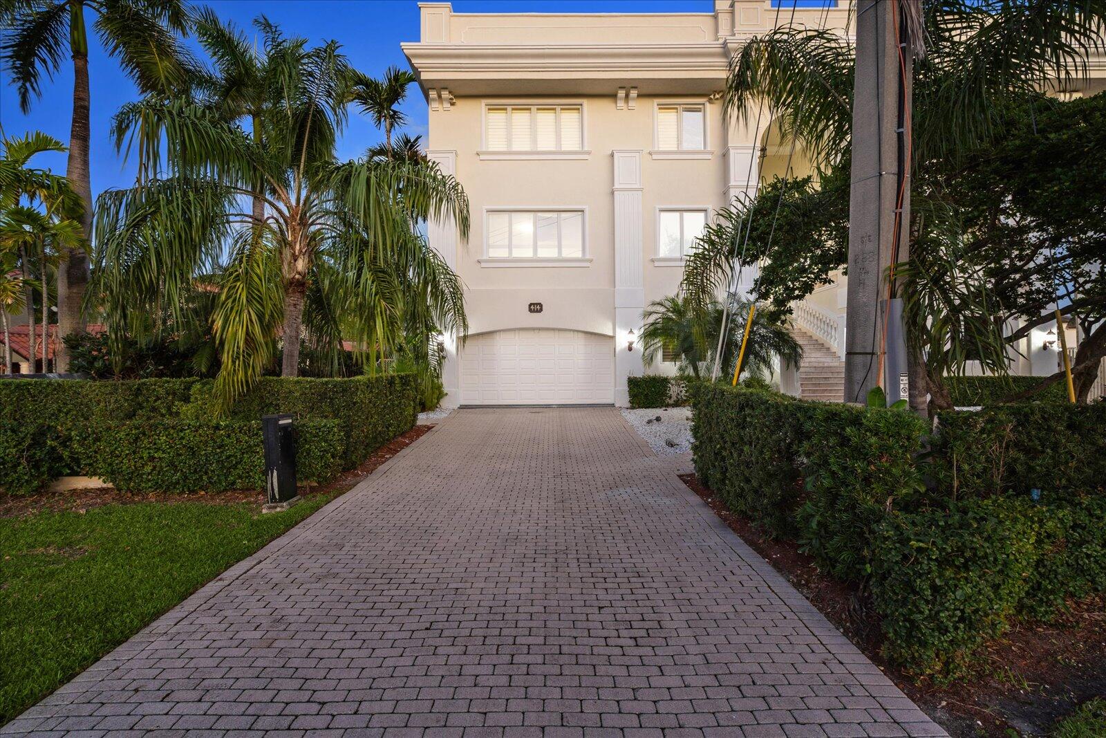 414 Riviera Isle Drive Fort Lauderdale, FL 33301 - Photo 65 of 70 a front view of a house with a yard and a garage