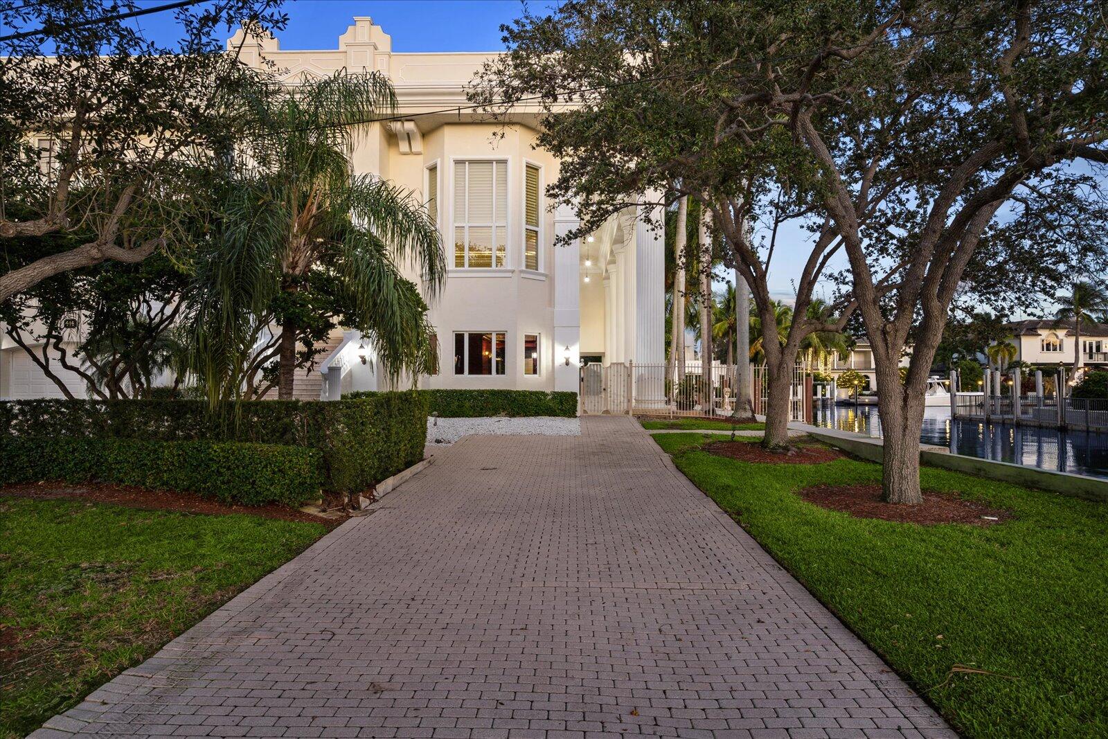 414 Riviera Isle Drive Fort Lauderdale, FL 33301 - Photo 66 of 70 a front view of a house with garden and trees