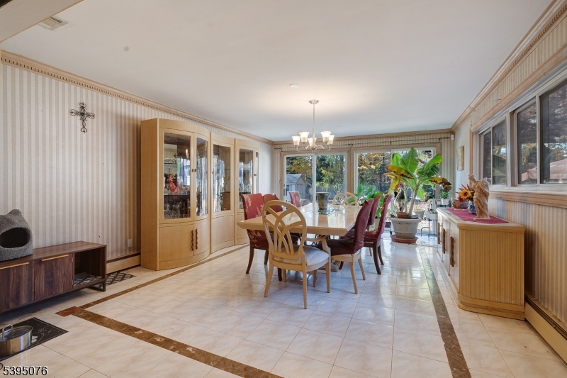 24 Woodland Road Clark, NJ 07066 - Photo 11 of 45 a dining room with furniture and a floor to ceiling window