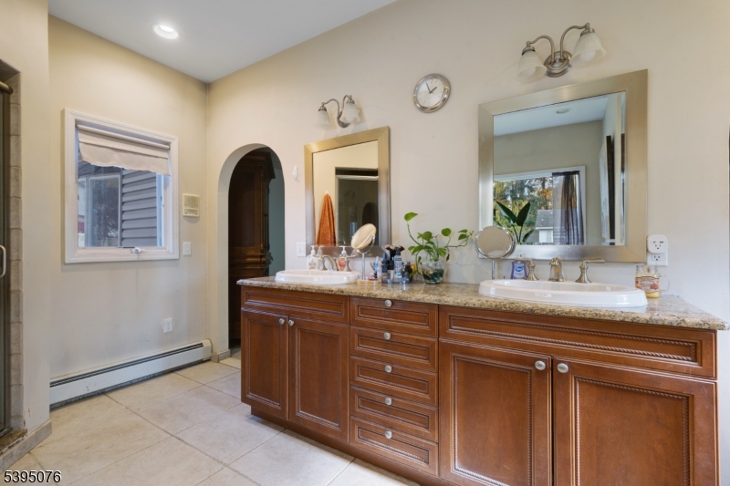 24 Woodland Road Clark, NJ 07066 - Photo 15 of 45 a bathroom with a granite countertop sink and a mirror