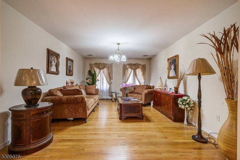 24 Woodland Road Clark, NJ 07066 - Photo 21 of 45 a living room with furniture and a chandelier