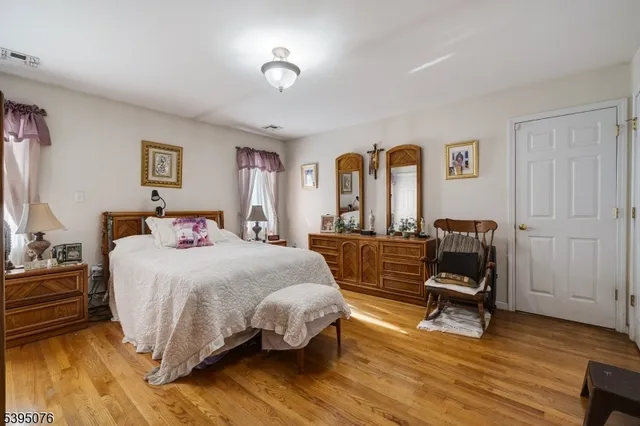 a bed room with a bed and a chair