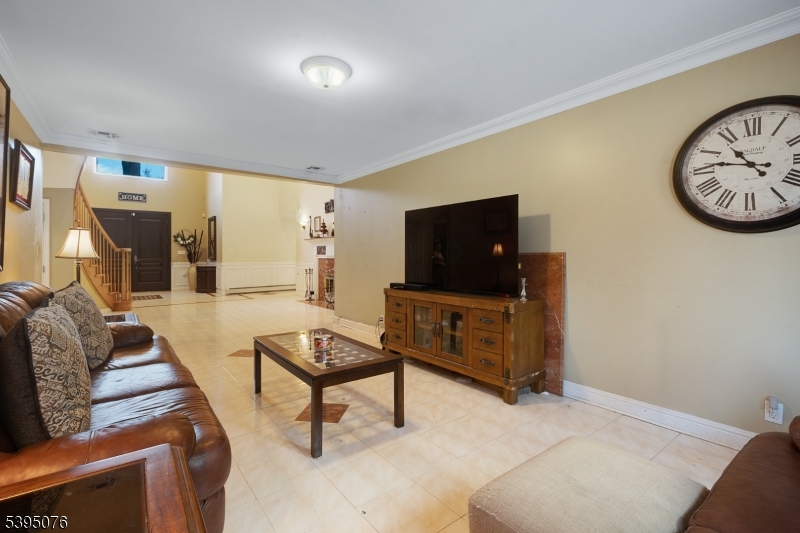 24 Woodland Road Clark, NJ 07066 - Photo 26 of 45 a living room with furniture and a flat screen tv