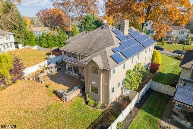 an aerial view of a house with a yard swimming pool and outdoor seating