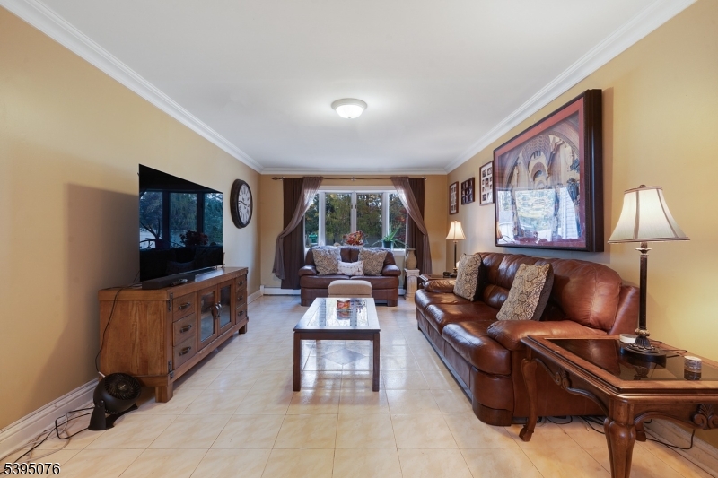 24 Woodland Road Clark, NJ 07066 - Photo 6 of 45 a living room with furniture and a flat screen tv
