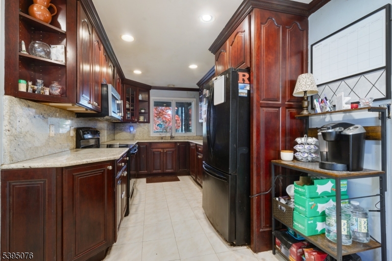 24 Woodland Road Clark, NJ 07066 - Photo 8 of 45 a kitchen with stainless steel appliances granite countertop a refrigerator a sink dishwasher a stove and a refrigerator