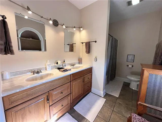 a spacious bathroom with a double vanity sink and a mirror
