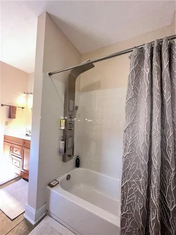 a bathroom with a bathtub and a shower