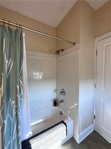 a bathroom with a tub and a shower