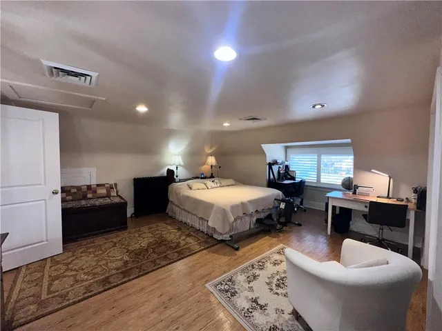 a large bedroom with a bed and glass door