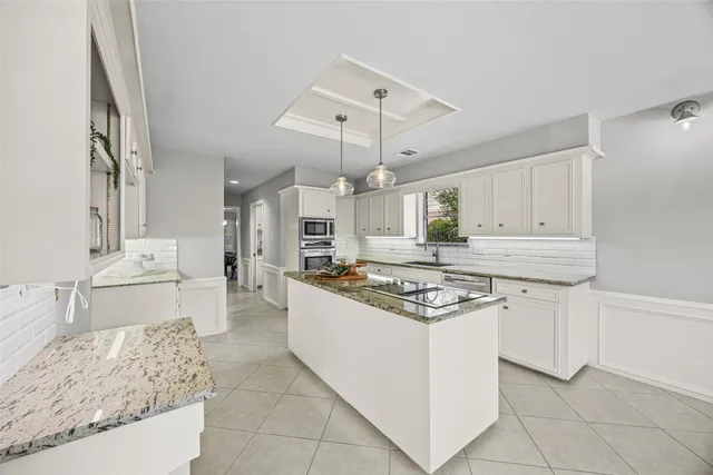 a kitchen with stainless steel appliances granite countertop a sink and stove