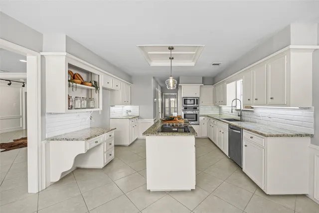 a kitchen with a sink stove and cabinets