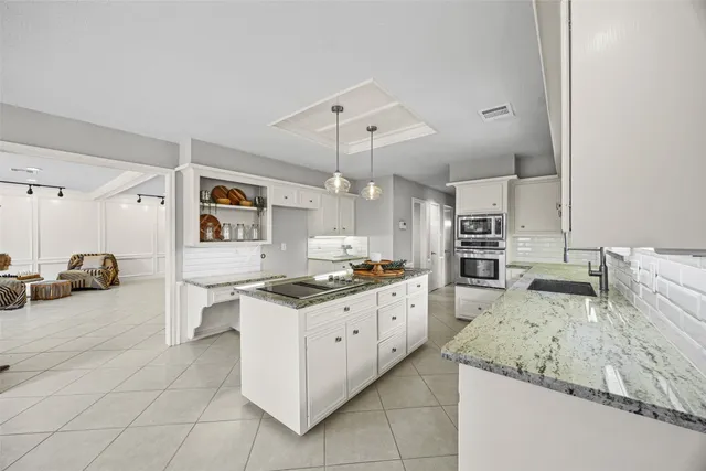 a kitchen with sink and cabinets