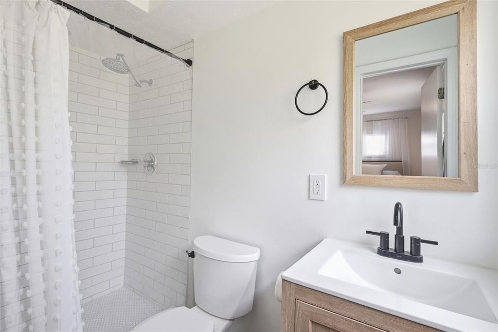 1291 Oxford Road Maitland, FL 32751 - Photo 28 of 37 a bathroom with a granite countertop toilet sink and mirror