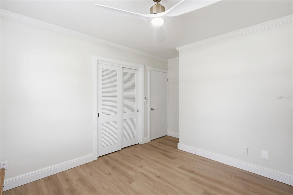 1291 Oxford Road Maitland, FL 32751 - Photo 30 of 37 an empty room with wooden floor and ceiling fan