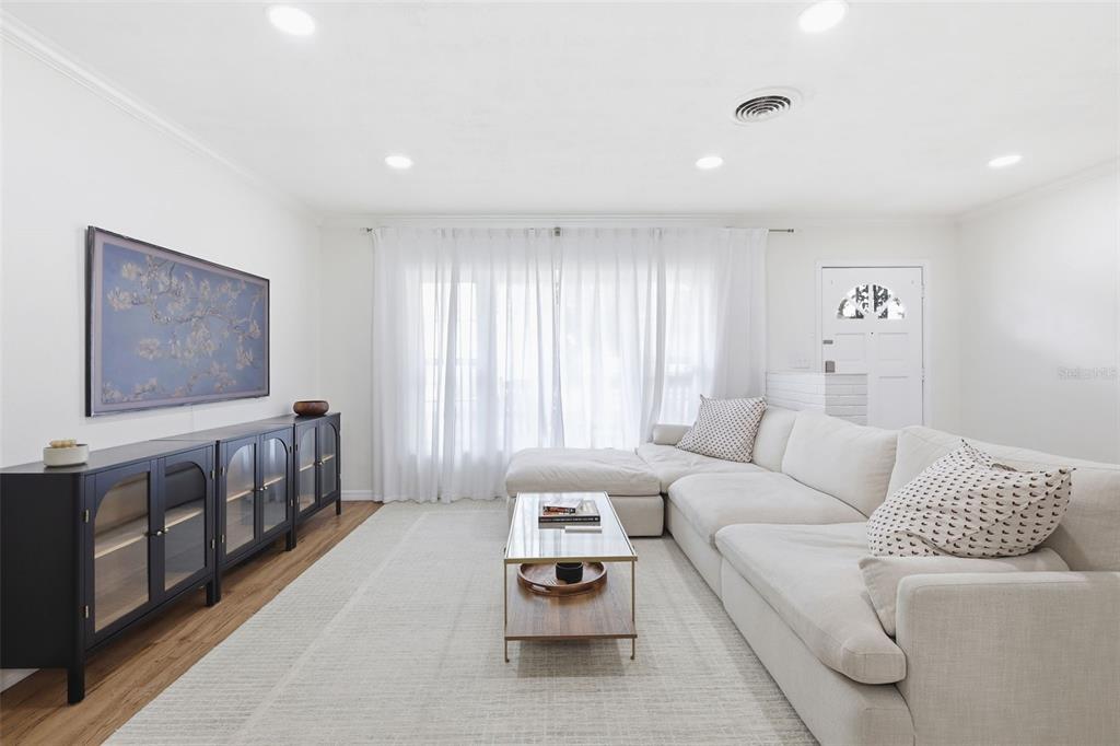 1291 Oxford Road Maitland, FL 32751 - Photo 7 of 37 a living room with furniture and a flat screen tv
