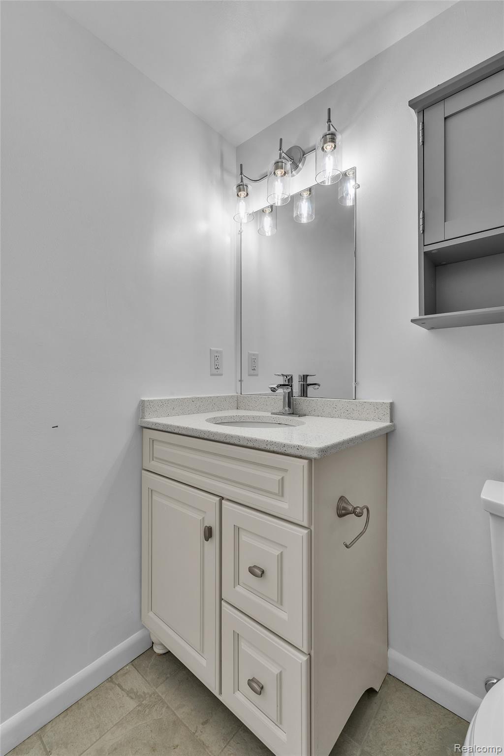 7000 Woonsocket Street Canton, MI 48187 - Photo 42 of 65 Bathroom vanity featuring a light-colored countertop, integrated sink, and brushed nickel faucet