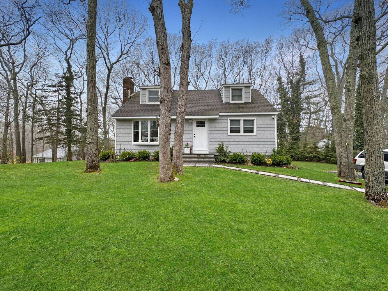 23 Bittersweet Avenue Hampton Bays, NY 11946 - Photo 1 of 17 front view of house with a yard