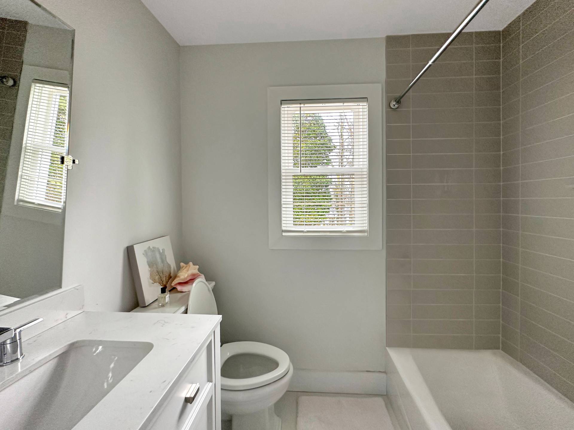23 Bittersweet Avenue Hampton Bays, NY 11946 - Photo 11 of 17 a bathroom with a sink toilet and bathtub