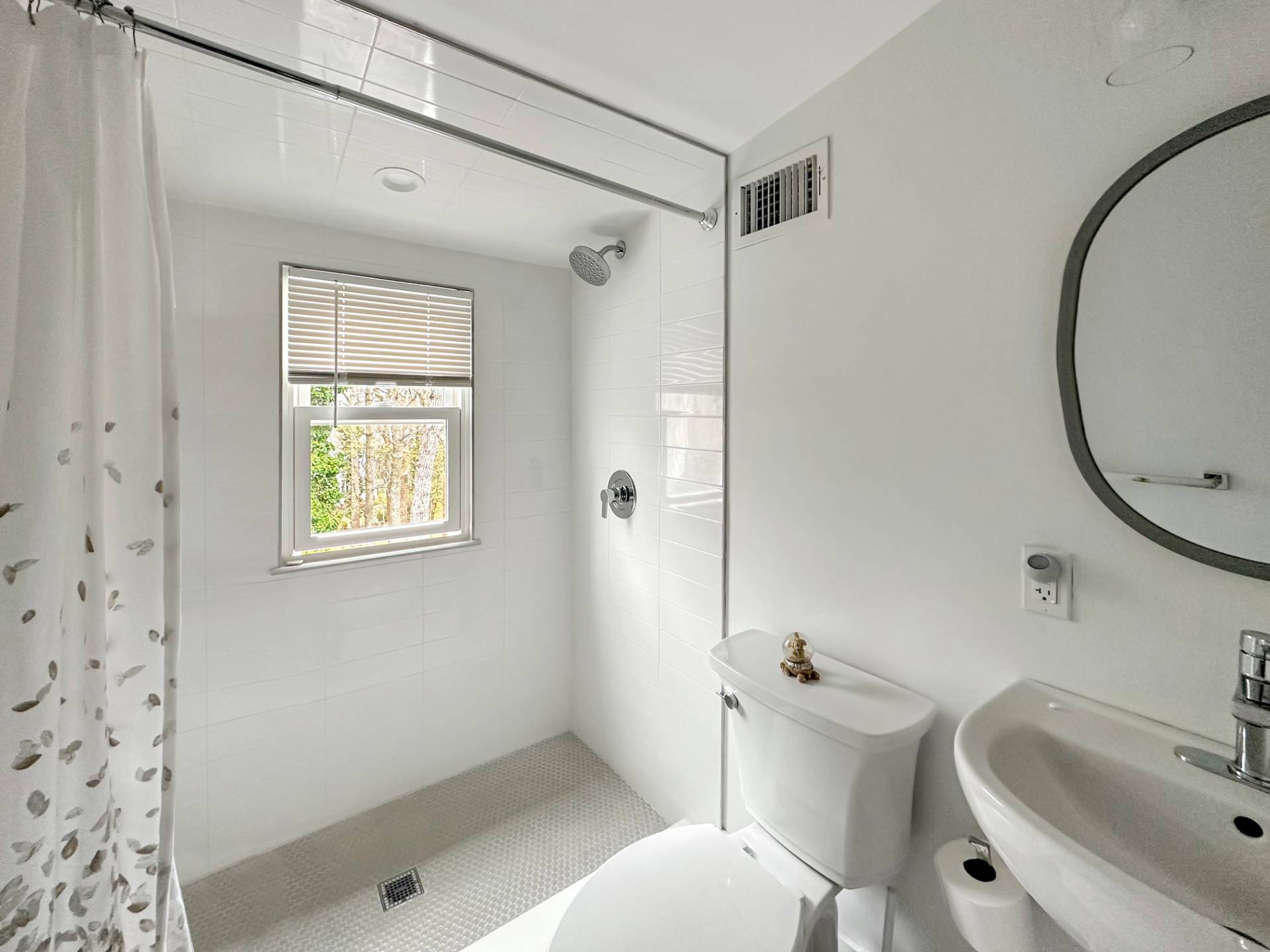 23 Bittersweet Avenue Hampton Bays, NY 11946 - Photo 13 of 17 a bathroom with a sink a toilet and shower