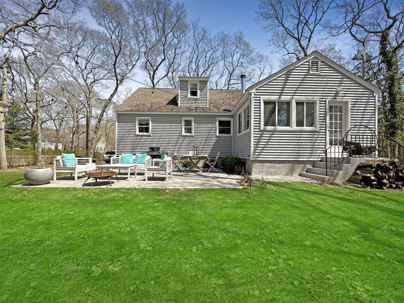 23 Bittersweet Avenue Hampton Bays, NY 11946 - Photo 15 of 17 a front view of a house with a garden