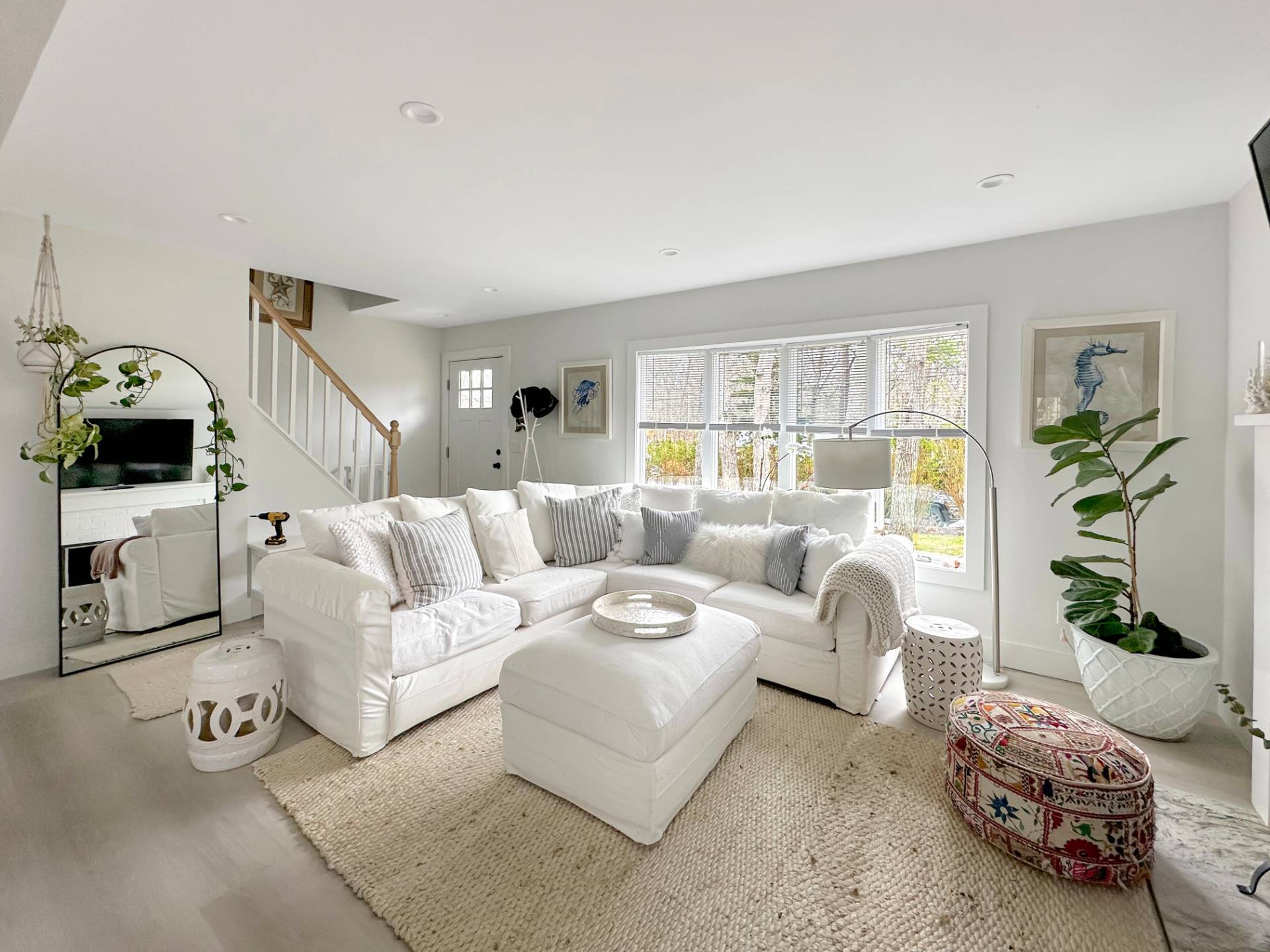 23 Bittersweet Avenue Hampton Bays, NY 11946 - Photo 2 of 17 a living room with furniture a fireplace and a window