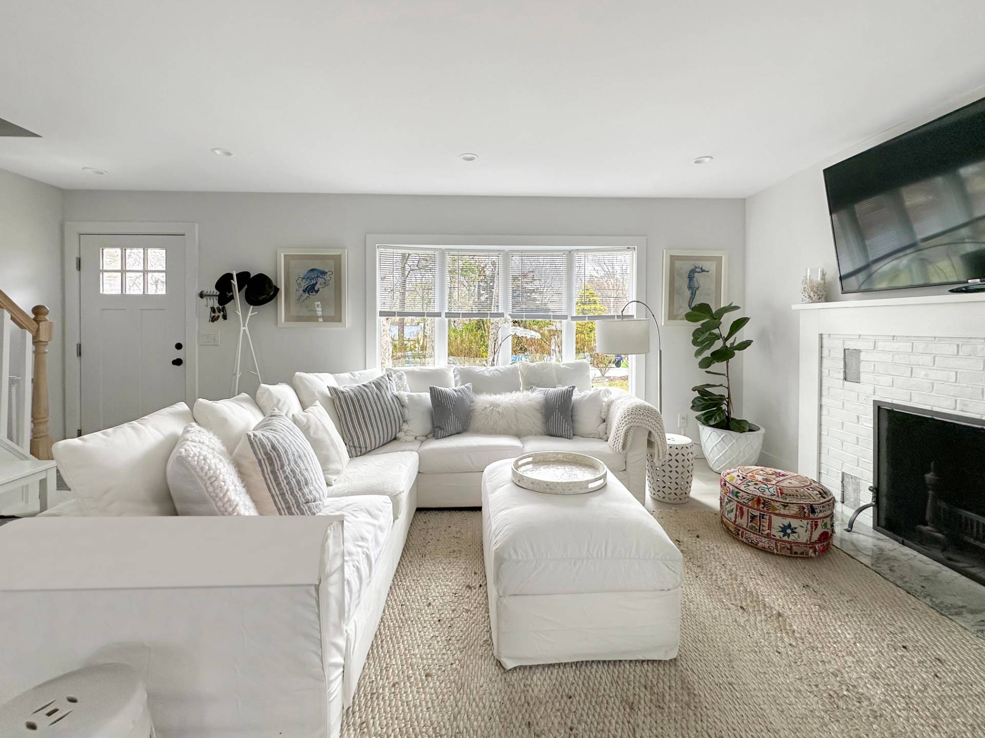 23 Bittersweet Avenue Hampton Bays, NY 11946 - Photo 3 of 17 a living room with furniture fireplace and a flat screen tv