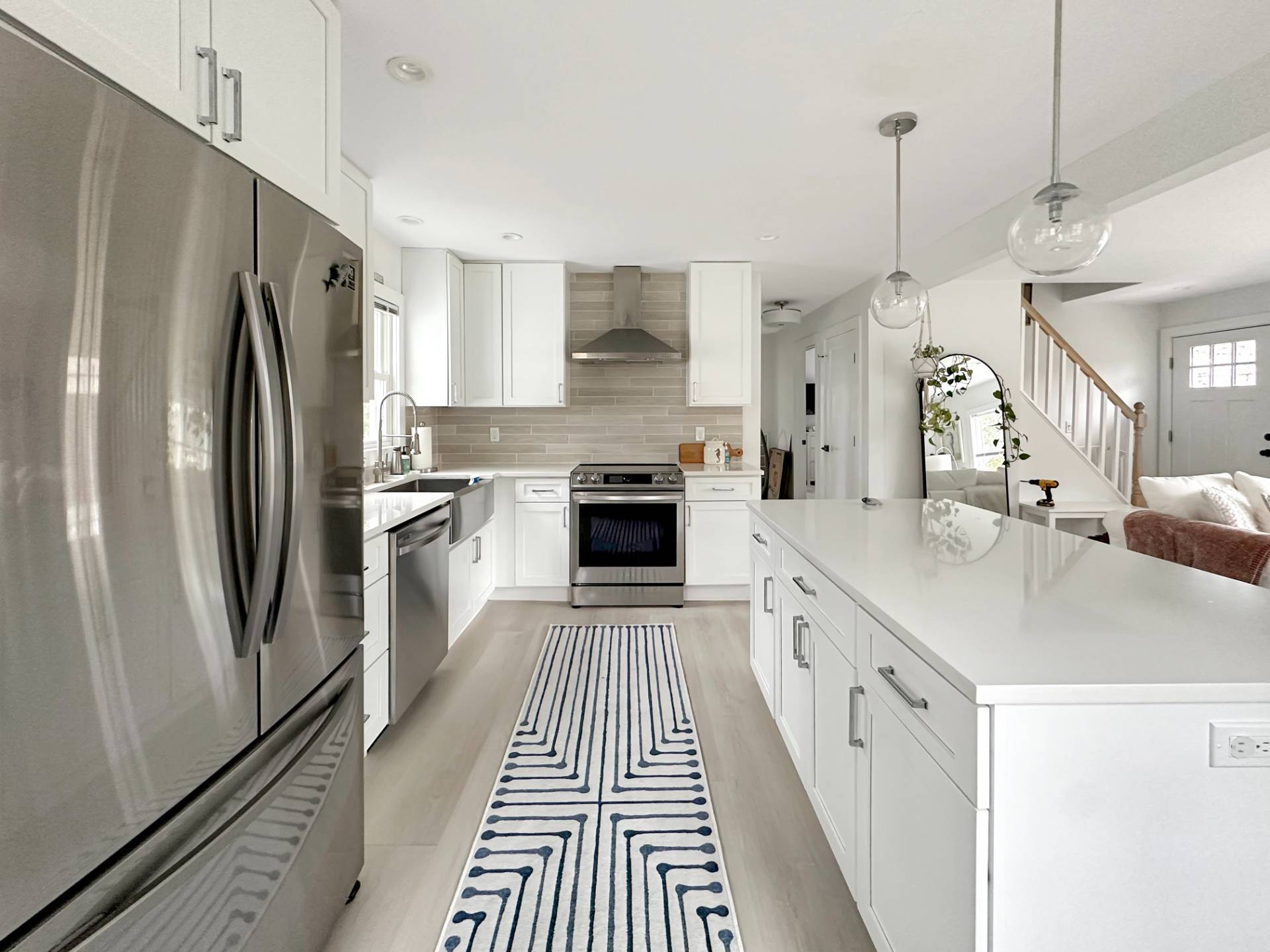 23 Bittersweet Avenue Hampton Bays, NY 11946 - Photo 8 of 17 a large kitchen with a stove and a refrigerator