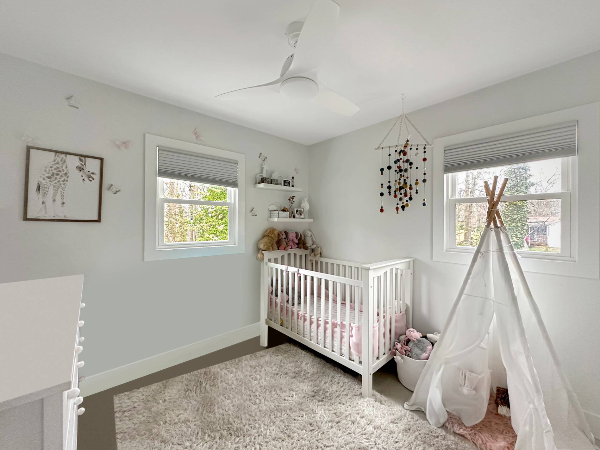 23 Bittersweet Avenue Hampton Bays, NY 11946 - Photo 10 of 17 a view of a bedroom with baby crib and a window