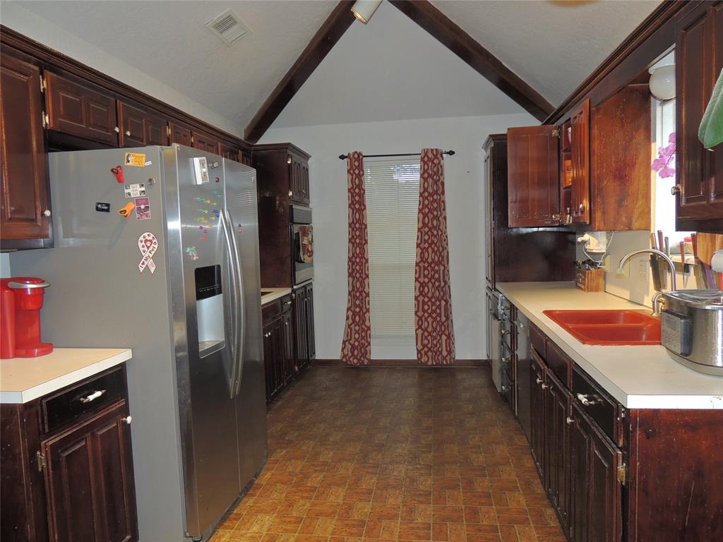 5518 Chimney Rock Road Abilene, TX 79606 - Photo 12 of 29 a kitchen with stainless steel appliances granite countertop a refrigerator a stove and a sink