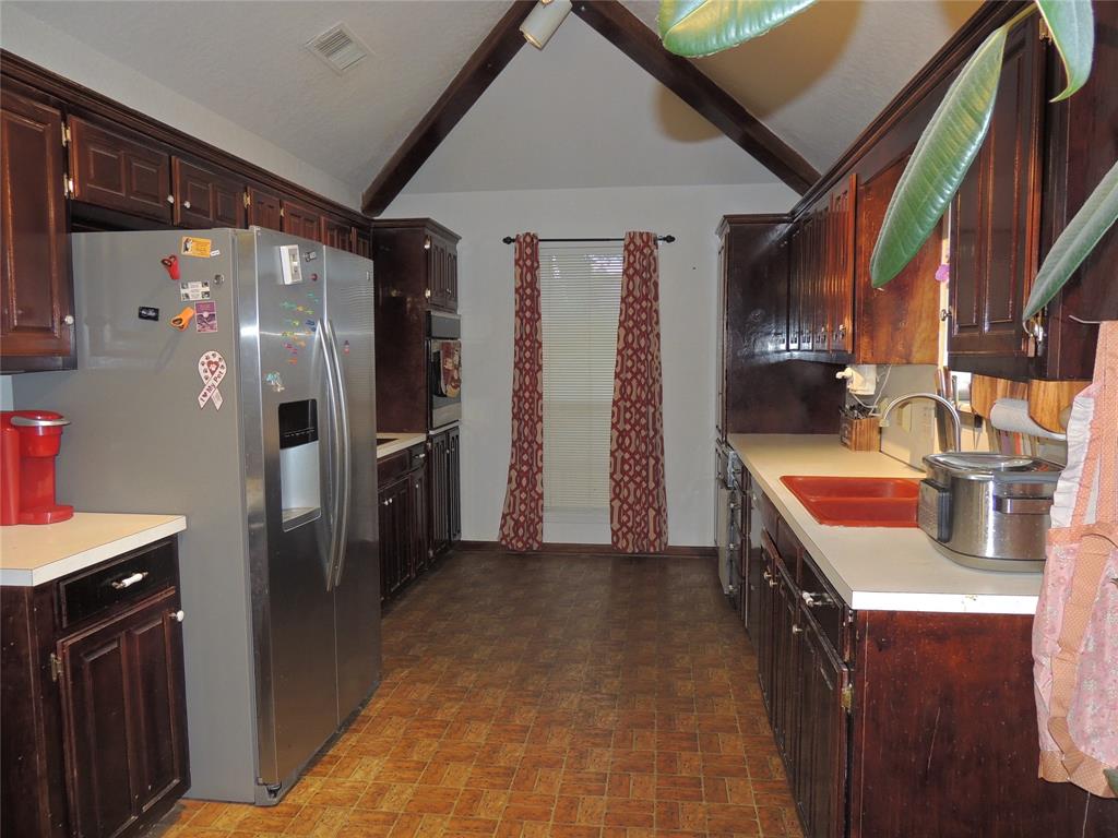5518 Chimney Rock Road Abilene, TX 79606 - Photo 14 of 29 a kitchen with stainless steel appliances kitchen island a refrigerator and a stove