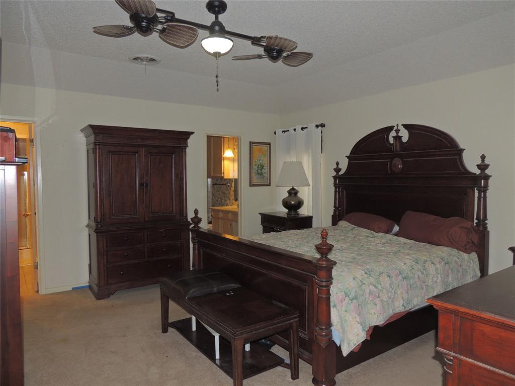 5518 Chimney Rock Road Abilene, TX 79606 - Photo 19 of 29 a living room with a bed a dresser and potted plants on the table