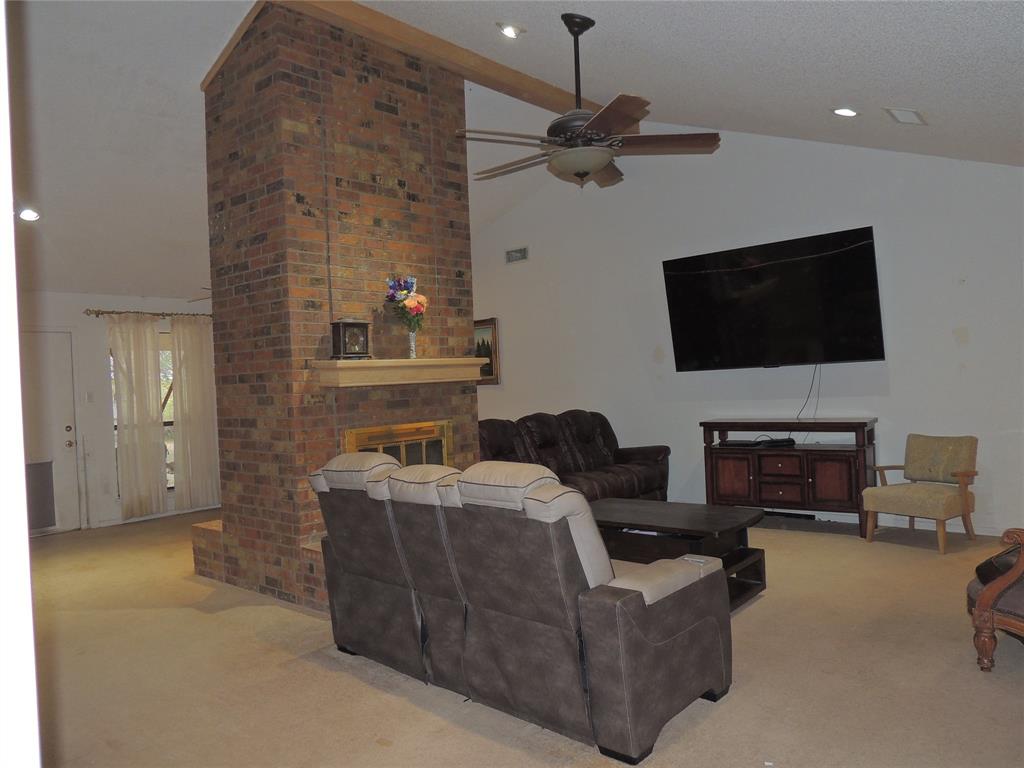 5518 Chimney Rock Road Abilene, TX 79606 - Photo 7 of 29 a living room with furniture a flat screen tv and a fireplace