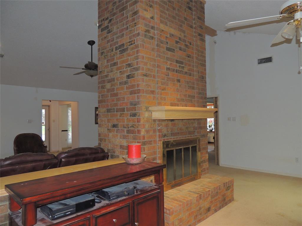 5518 Chimney Rock Road Abilene, TX 79606 - Photo 10 of 29 a room with a fireplace and a potted plant on the counter