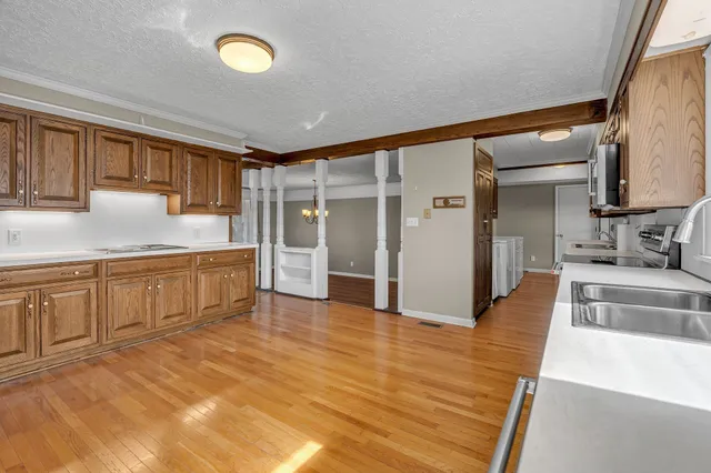 a large kitchen with cabinets and wooden floor