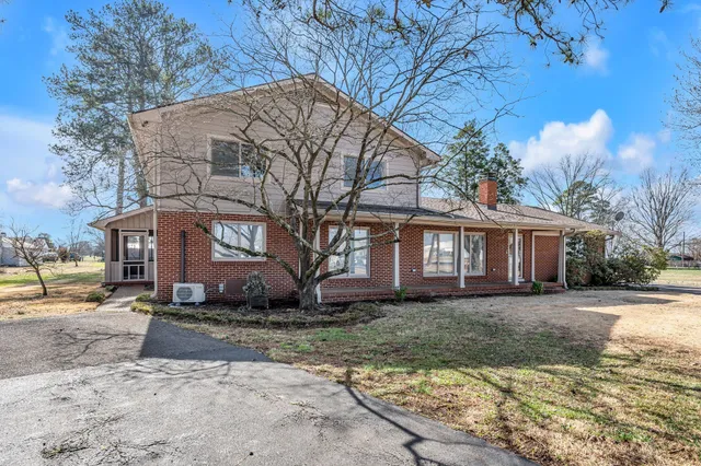 a view of a house with a yard covered in snow