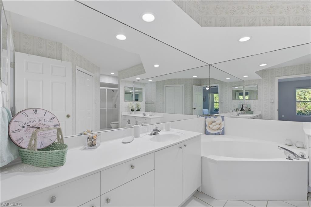 3605 Corinthian Way Naples, FL 34105 - Photo 12 of 33 a bathroom with a double vanity sink and a mirror