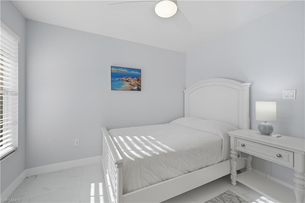 3605 Corinthian Way Naples, FL 34105 - Photo 14 of 33 a bedroom with a bed and a window