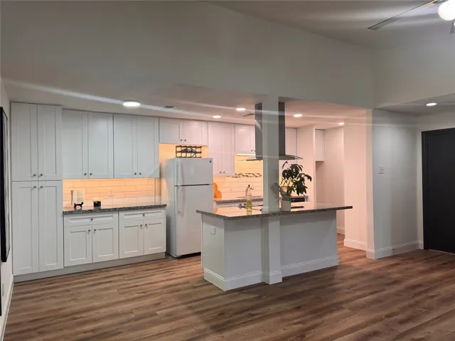 a kitchen with stainless steel appliances a sink and a refrigerator