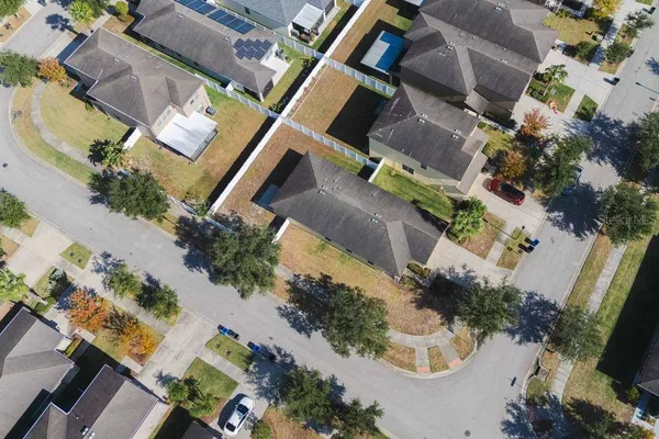 an aerial view of a house with a yard
