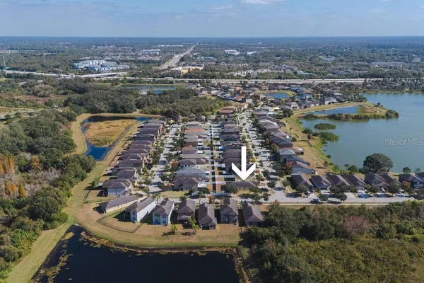 an aerial view of a house with a lake view