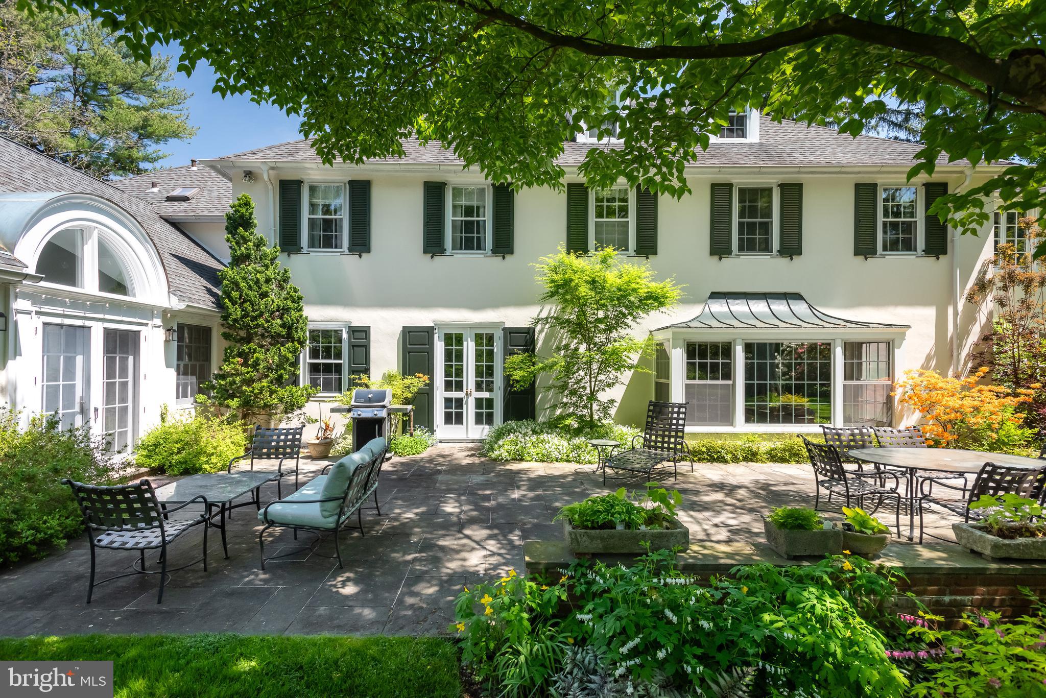 750 Harrison Road Villanova, PA 19085 - Photo 35 of 43 a front view of a house with garden and porch