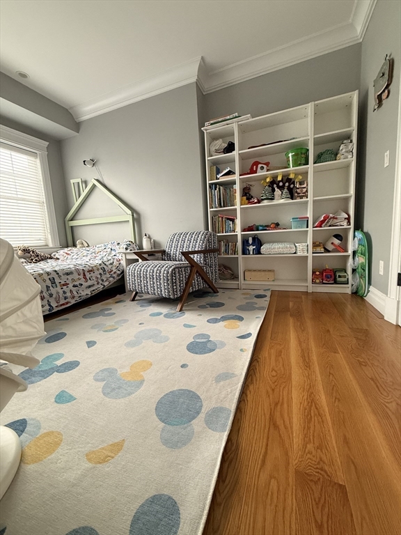 161 Tudor Street, Unit 3 Boston, MA 02127 - Photo 14 of 27 a bedroom with a bed and a wooden floor