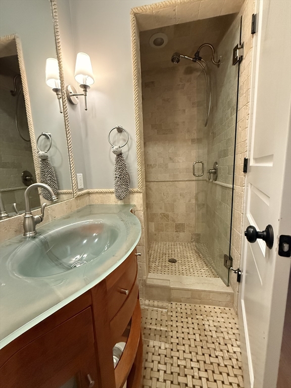 161 Tudor Street, Unit 3 Boston, MA 02127 - Photo 16 of 27 a bathroom with a sink a toilet and shower