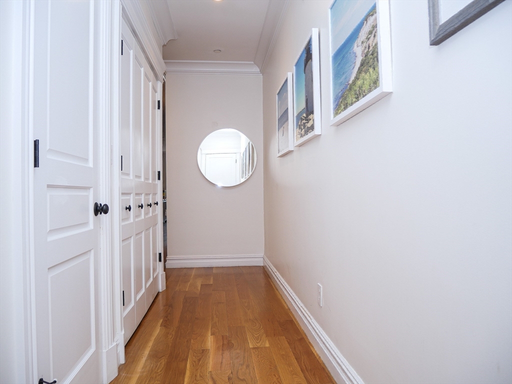 161 Tudor Street, Unit 3 Boston, MA 02127 - Photo 21 of 27 a view of a hallway with wooden floor