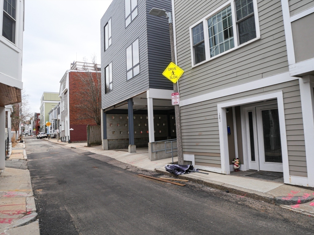 161 Tudor Street, Unit 3 Boston, MA 02127 - Photo 25 of 27 a front view of a house with a garage