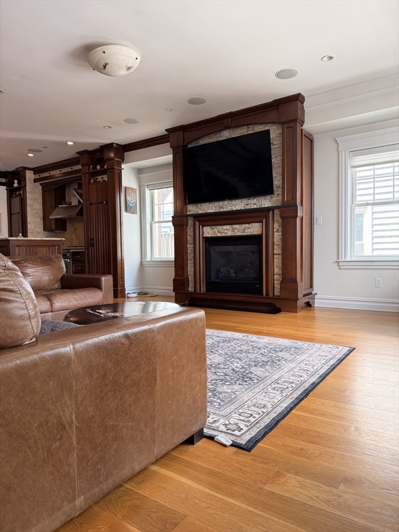 161 Tudor Street, Unit 3 Boston, MA 02127 - Photo 6 of 27 a living room with furniture flat screen tv and a fireplace