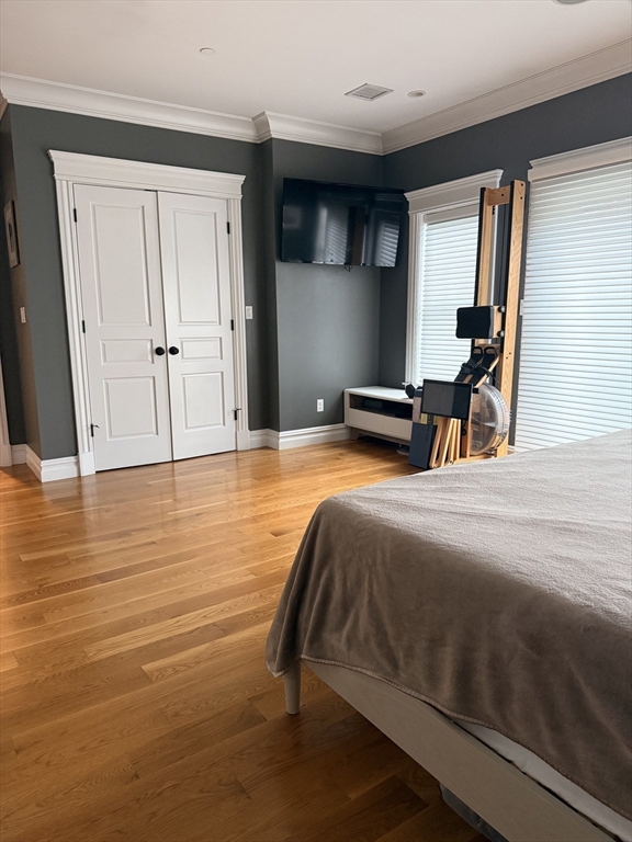 161 Tudor Street, Unit 3 Boston, MA 02127 - Photo 10 of 27 a bedroom with a bed and wooden floor