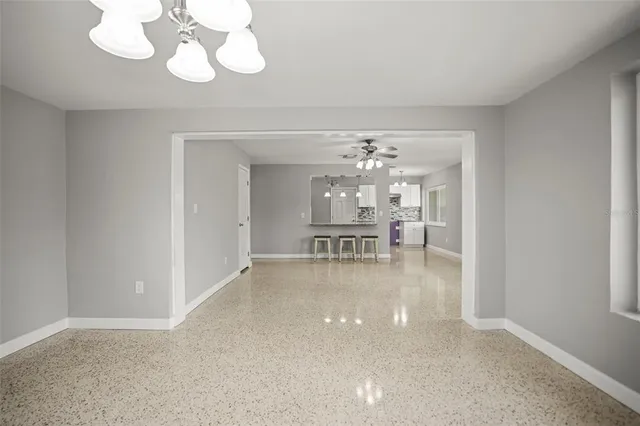 a view of a livingroom with a furniture wooden floor and chandelier